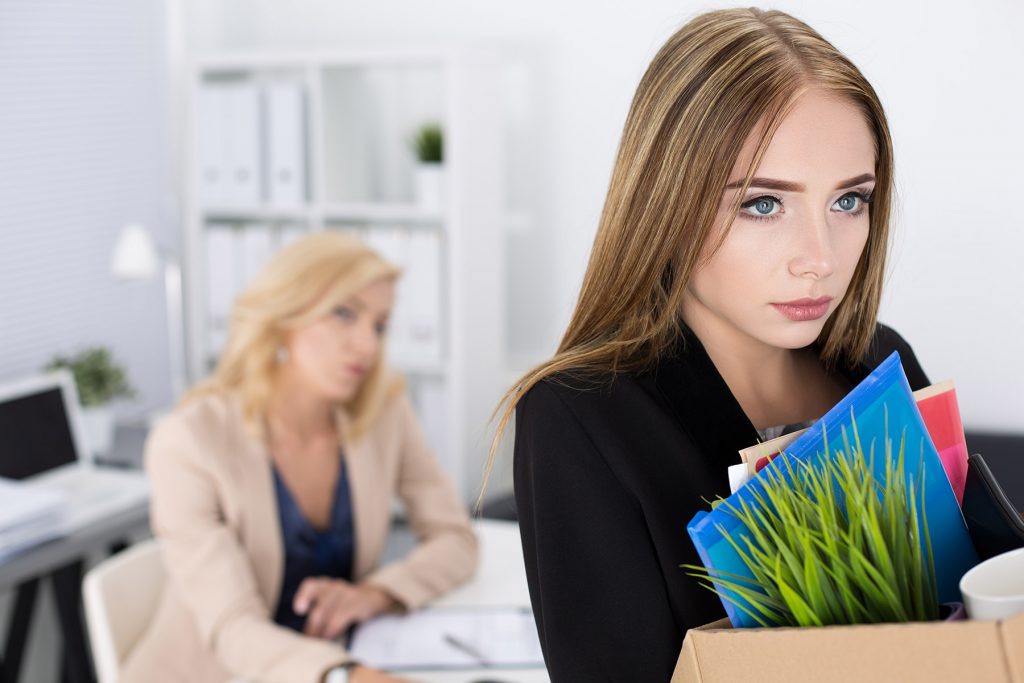 Young Woman Packing Up Her Stuff at the Office After Being Fired