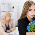 Young Woman Packing Up Her Stuff at the Office After Being Fired